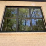 beautiful black windows on light brick house with henley supply