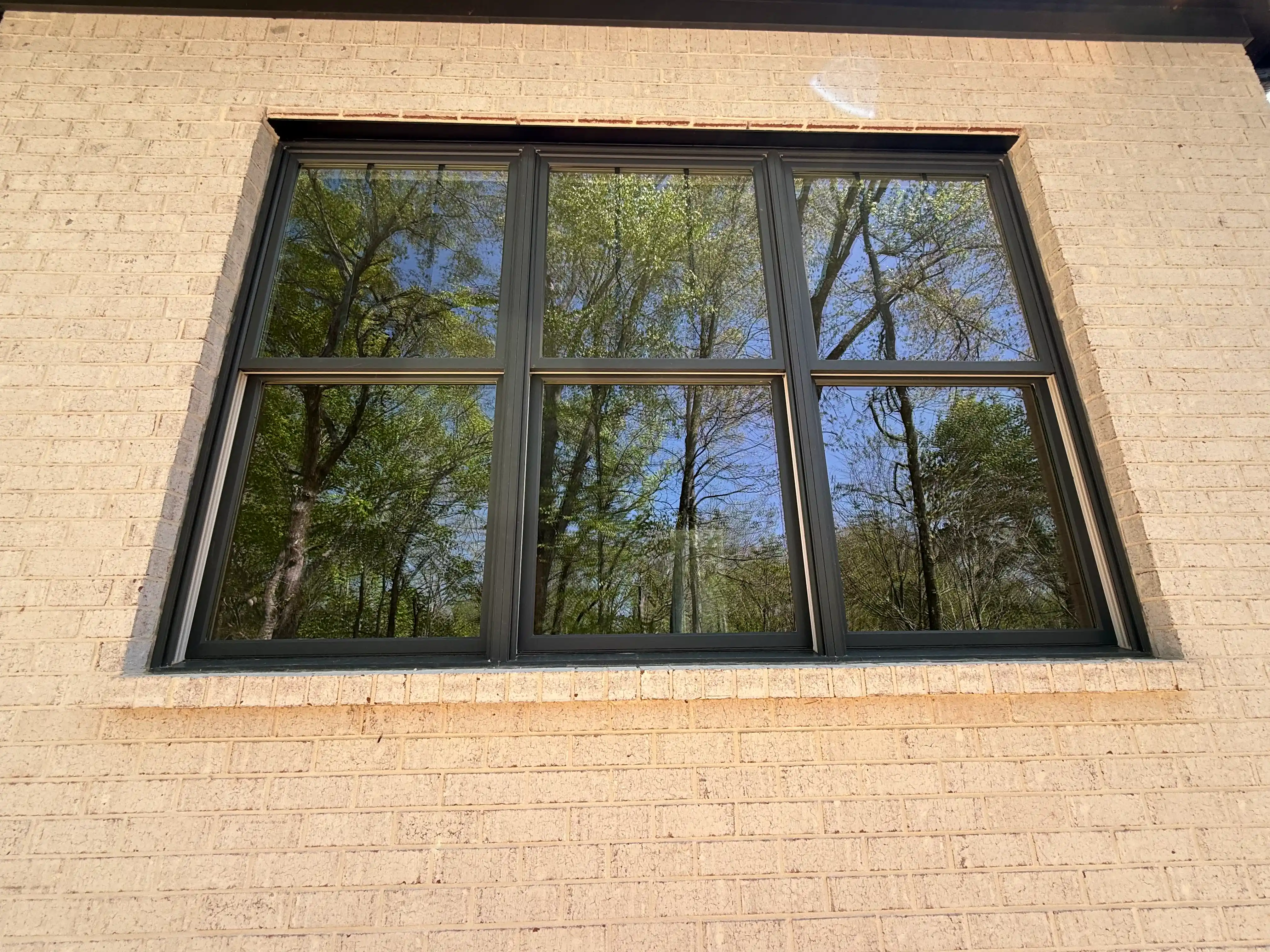beautiful black windows on light brick house with henley supply